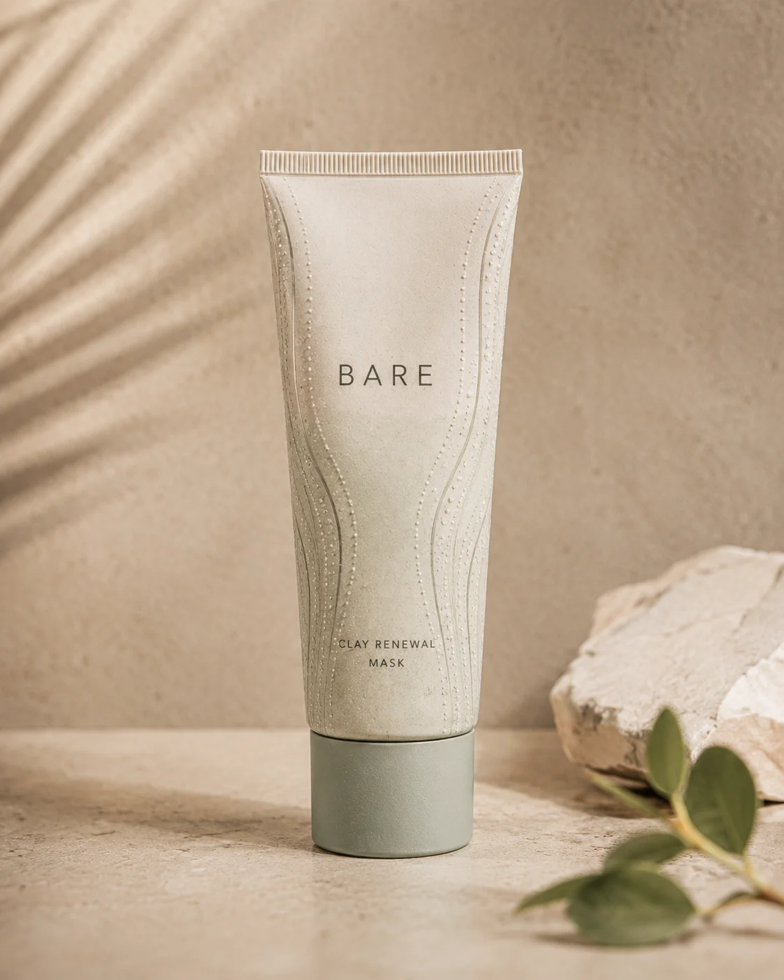 Bare body oil bottle photographed in nature with soft directional light