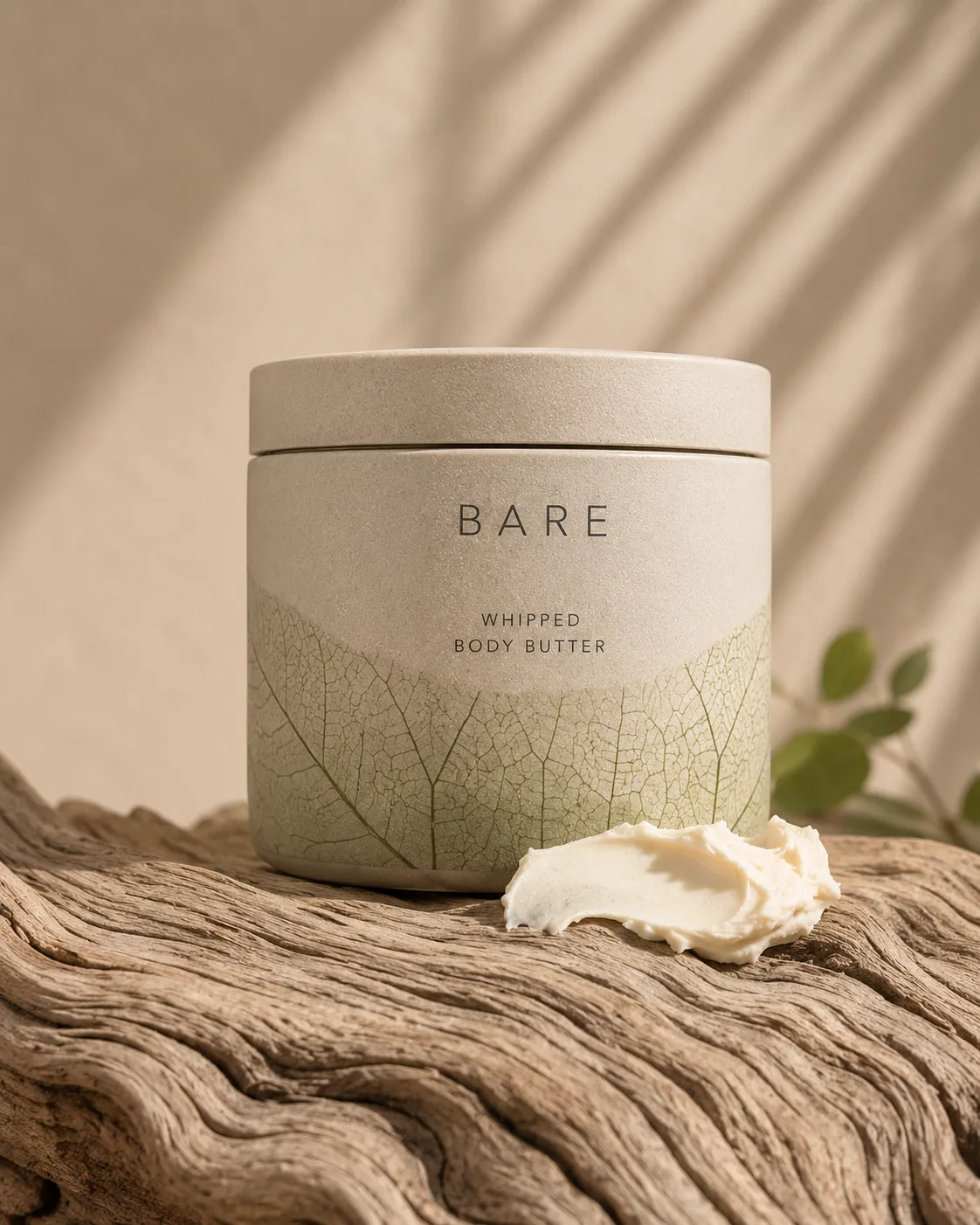 Bare product on coastal sand bathed in warm golden-hour light